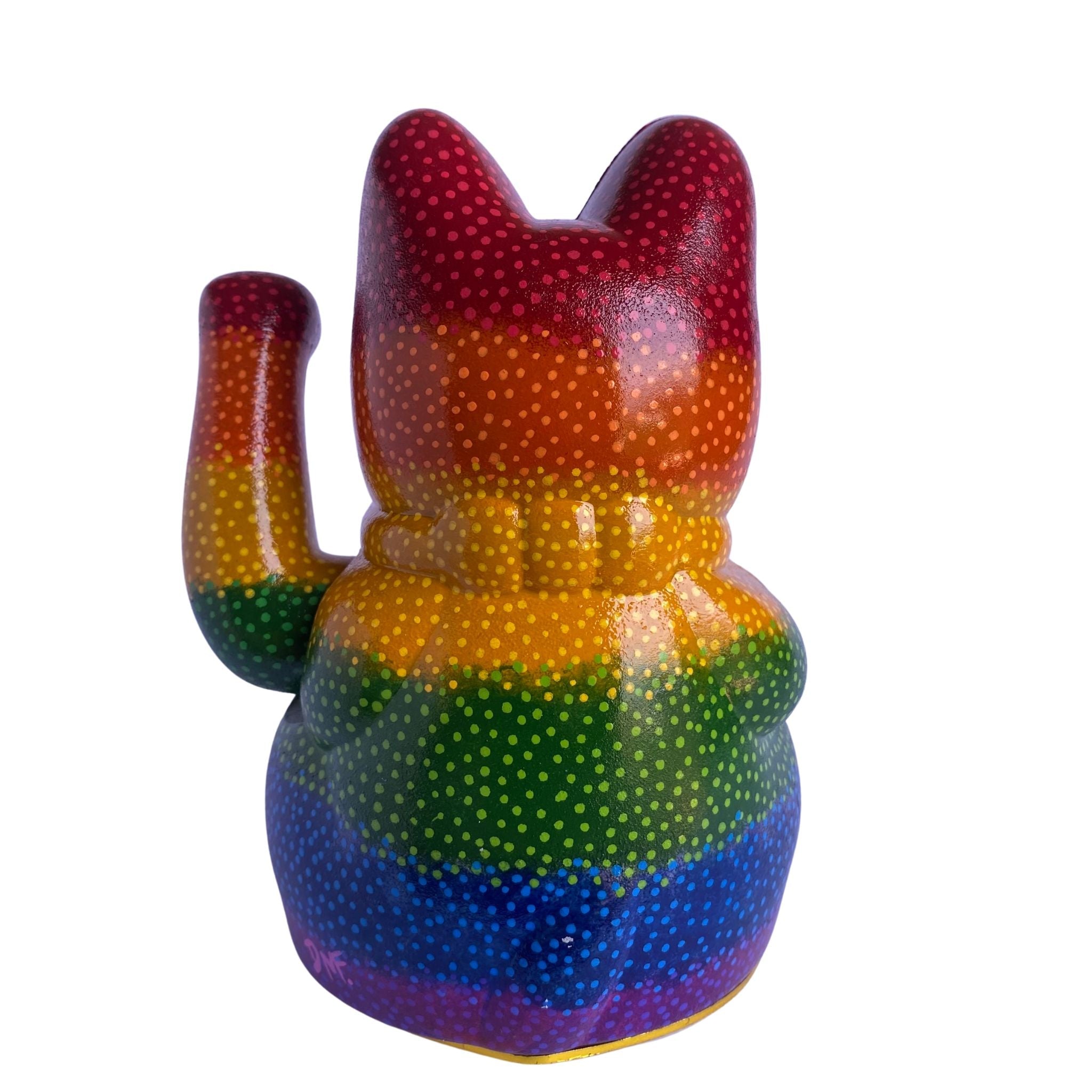 Rainbow-colored cat-shaped object with a textured surface on a white background
