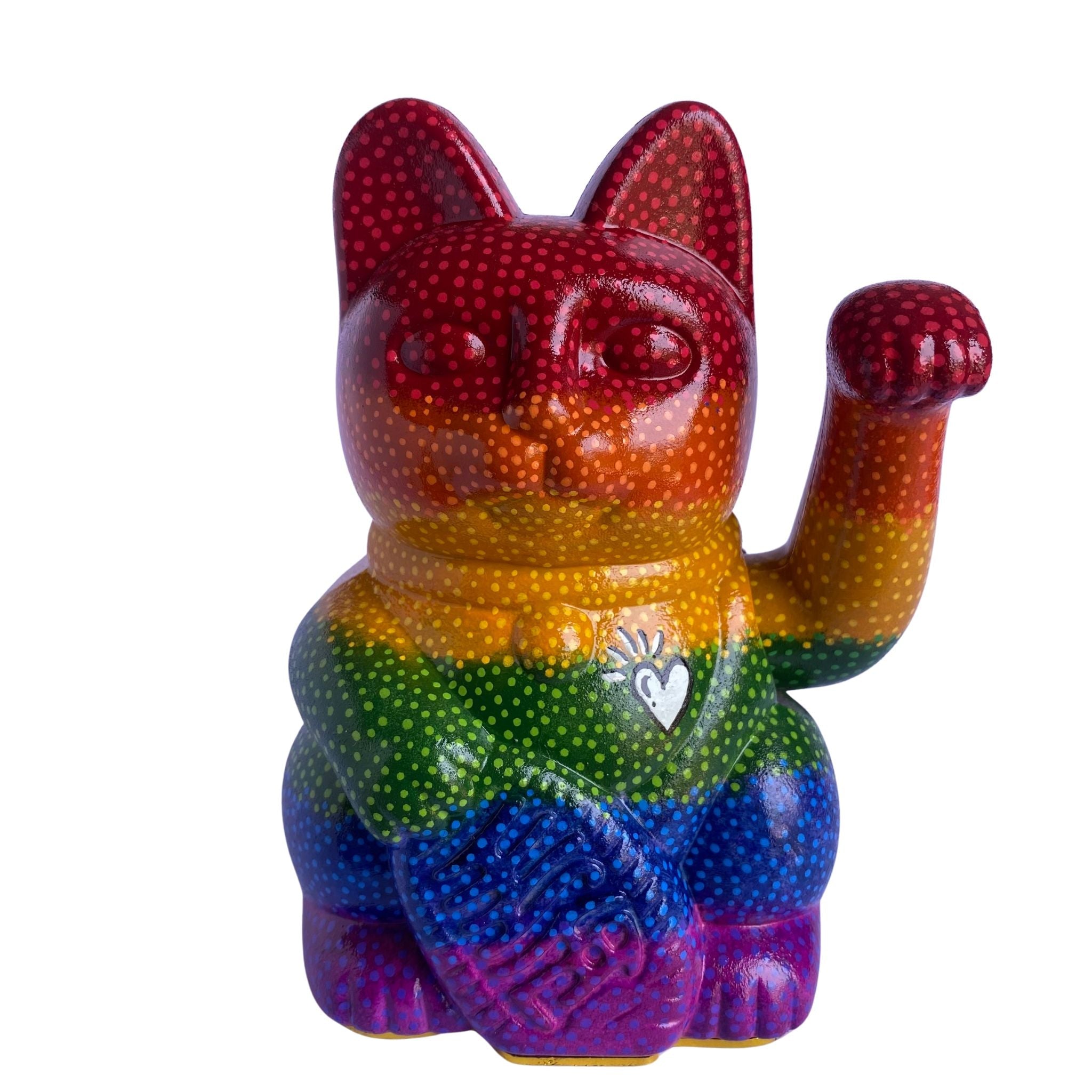 Colorful rainbow cat figurine with a white heart symbol on a white background