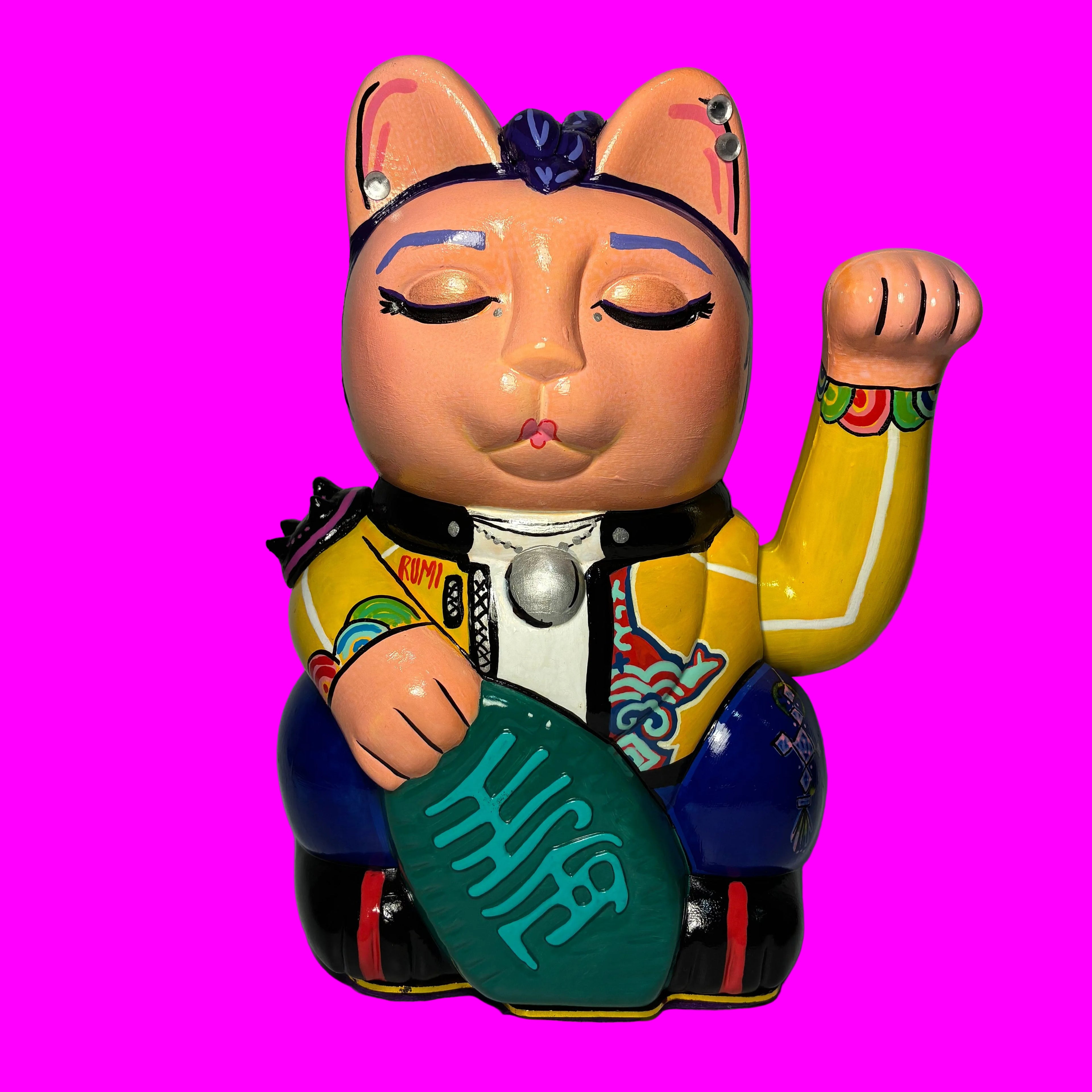 Colorful lucky cat figure on a pink  background