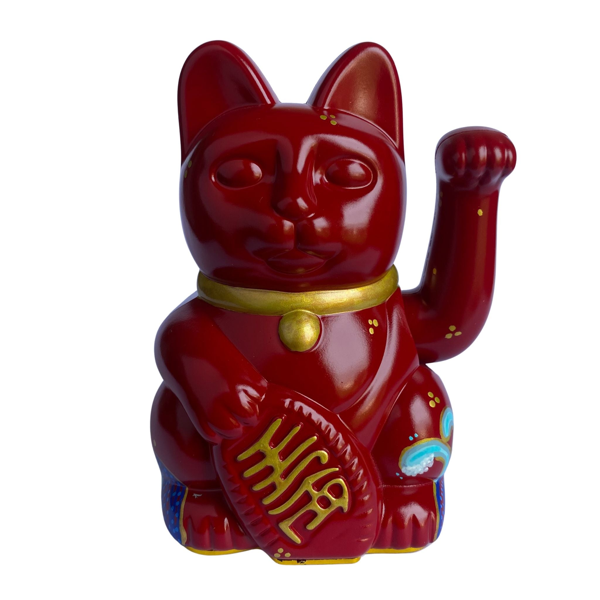 Red cat figurine with a gold paw on a white background